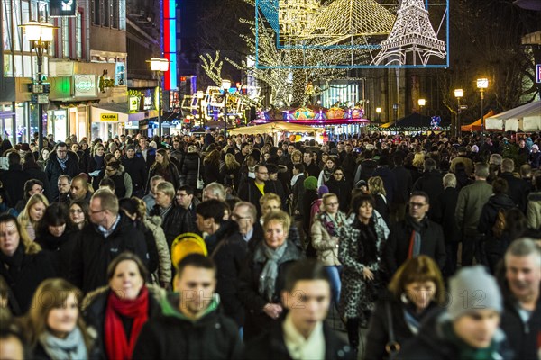 Crowds thronging between stores and Christmas market stalls