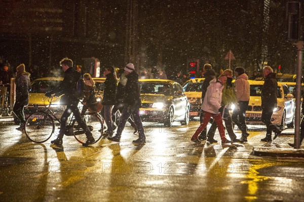 Cyclist and pedestrians with sleet