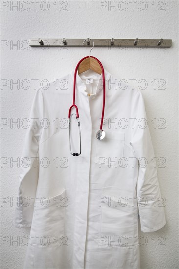 Doctor's coat hanging on a coat hanger on a coat rack