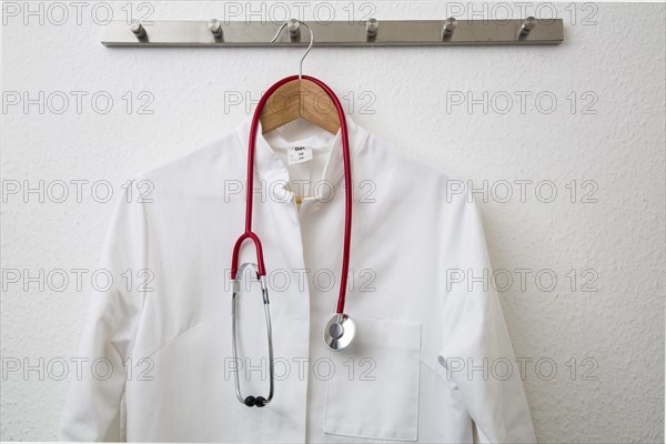 Doctor's coat hanging on a coat hanger on a coat rack
