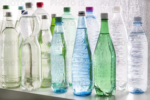 Different varieties of mineral water in bottles made of glass and plastic or PET