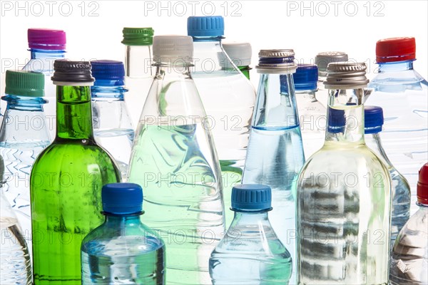 Different varieties of mineral water in bottles made of glass and plastic or PET