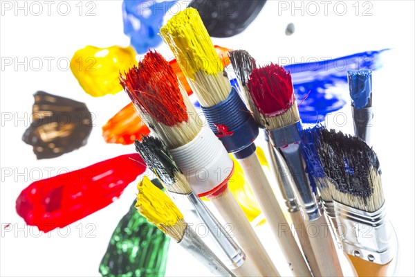 Different types of brushes with colourful acrylic paints