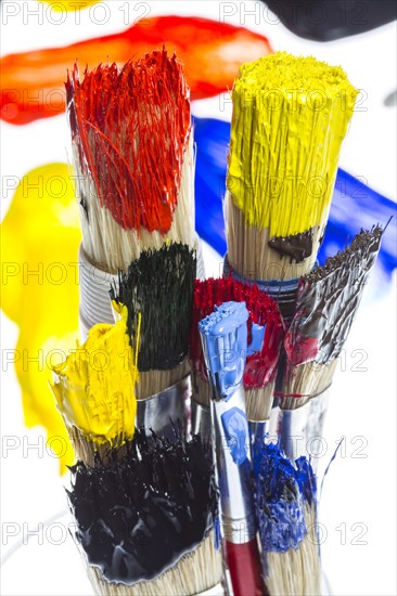 Different types of brushes with colourful acrylic paints