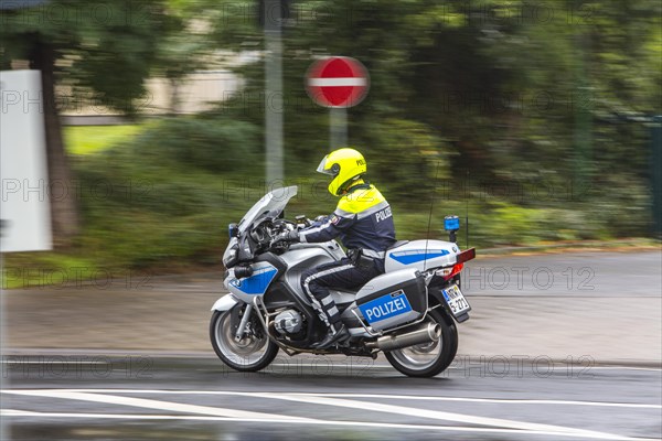 Policeman wearing a yellow helmet on a motorcycle