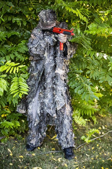 Policeman dressed in camouflage with a submachine gun HK MP5