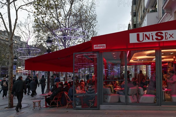 Sidewalk cafe on the Avenue des Champs Elysees street in the evening