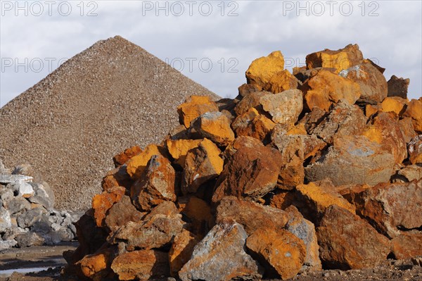 Stack of rusty ferruginous rocks waiting to be recycled