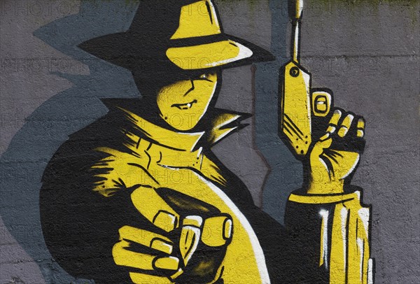 Man holding a pistol and holding a bullet in his outstretched hand