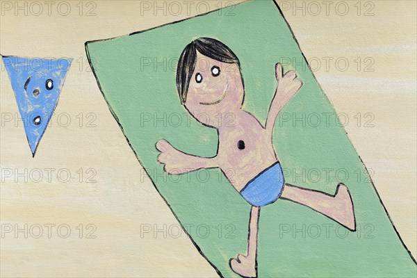 Boy lying on a beach towel