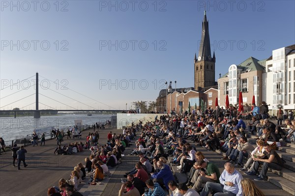 People sitting on a flight of steps in the evening sun