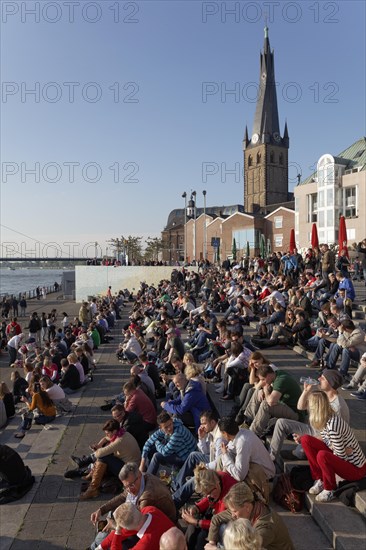 People sitting on a flight of steps in the evening sun