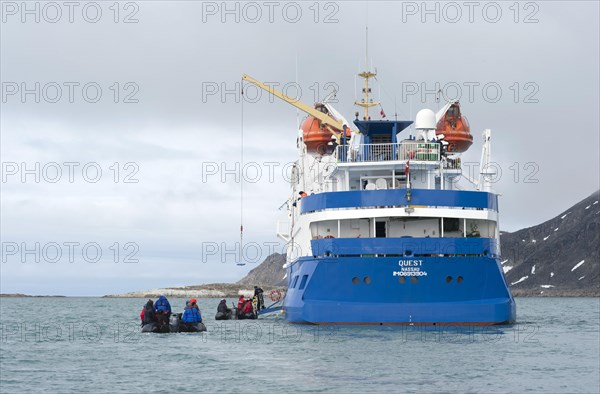 Passengers returning after being ashore in Zodiac inflatable boats to the expedition cruise ship