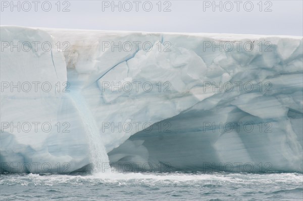 Meltwater waterfall at the glacier front of Brasvellbreen