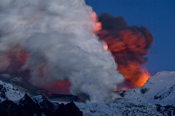 Cloud of ash from Eyjafjallajoekull volcano and a vapour cloud from lava flow in the Gigjoekull glacier tongue