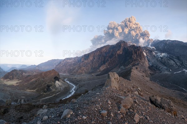Ash cloud from Eyjafjallajoekull volcano above a glacier and Porsmoerk valley