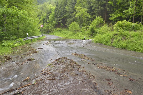 Road in the Harz region covered in water and debris after heavy rainfalls