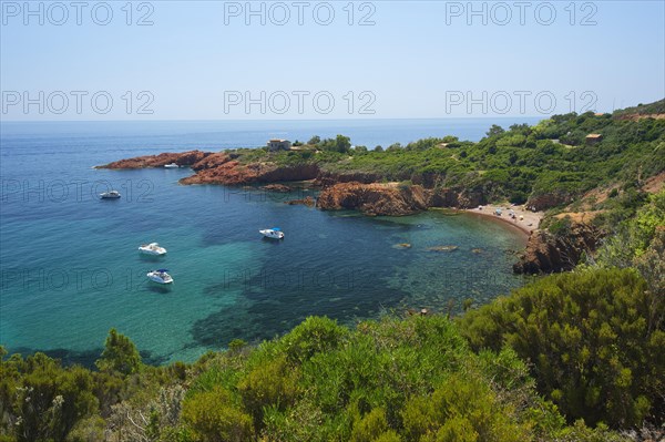 Calanque bay with boats at Cap Roux in the Esterel mountains