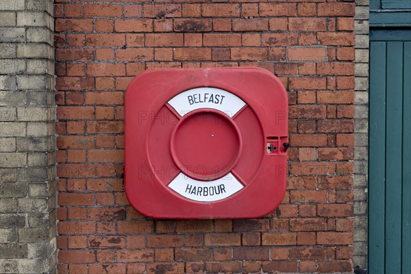 Life buoy on a brick wall