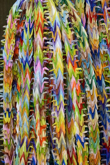 Garlands of folded objects on sale as good luck charms