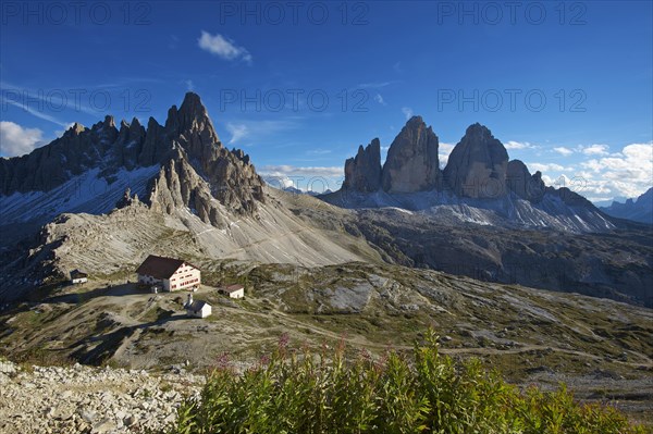 Dreizinnenhuette or Three Peaks Alpine hut and chapel in front of Paternkofel Mountain and the north face of the Three Peaks