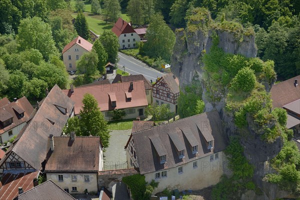 Half-timbered houses next towering karst rocks