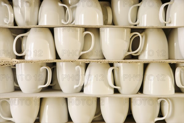 Cups piled between cardboard