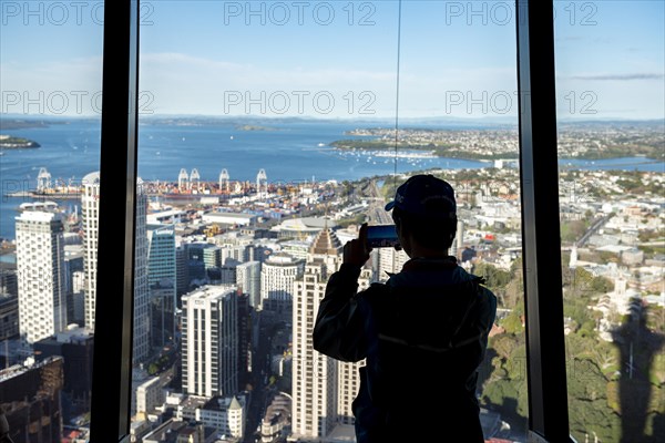 Tourist photographs the view with his smartphone