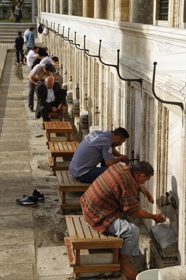 Devout Muslims making ablution at the fountain in front of Suleymaniye Mosque