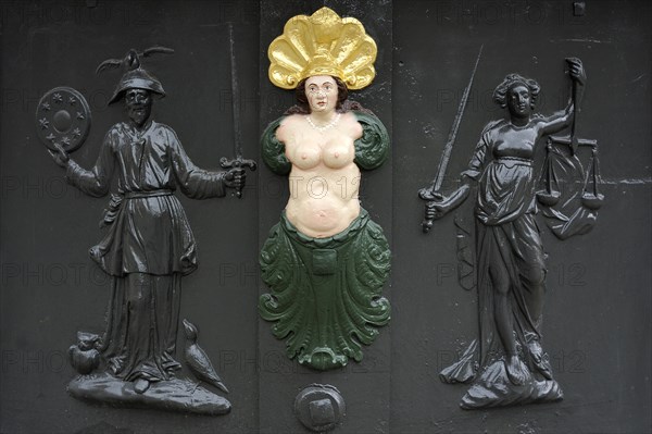 Three relief figures on Roehrenbrunnen fountain of 1727