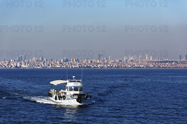 Fishing boat on the Marmara Sea with the Asian side of Istanbul