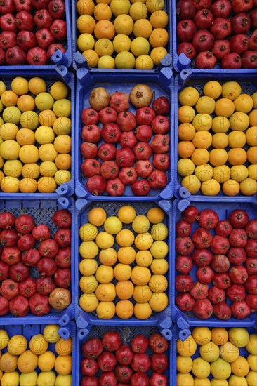 Oranges and pomegranates in crates