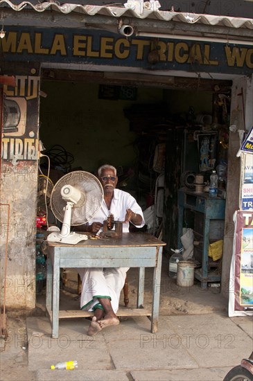 Electrician in front of his business