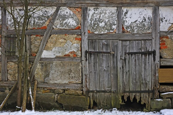 Rotten door of an old timber barn