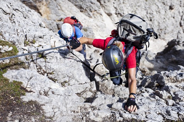 Mountain climbers during the ascent to the summit of Plattkofel Mountain via the Oskar Schuster Via Ferrata climbing route