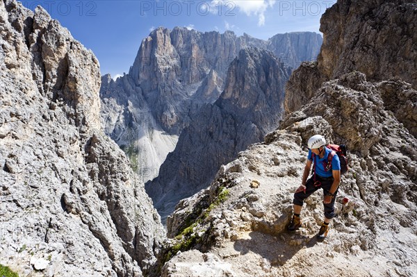 Mountain climber ascending to the summit of Sasso Piatto Mountain via the Oskar Schuster climbing route