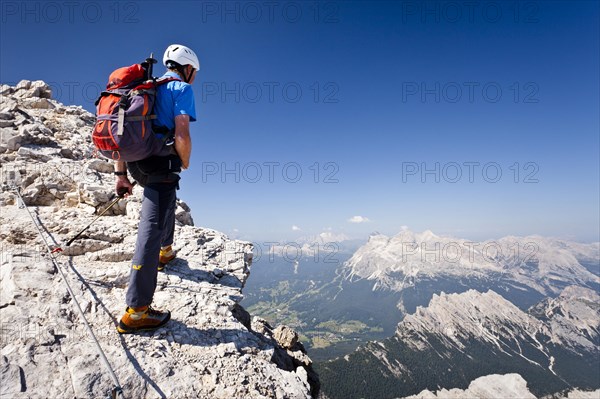 Mountain climber ascending the Via Ferrata Marino Bianchi climbing route on Monte Cristallo