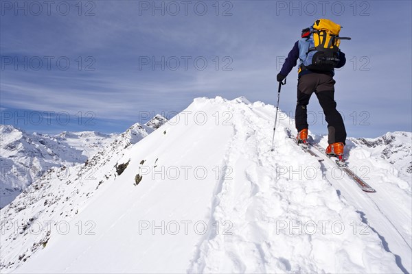 Cross country skier on the summit ridge of Ellesspitze Mountain