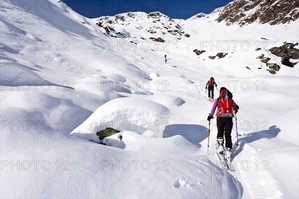 Cross country skiers ascending Wurzer Alpenspitz Mountain in the Ridnauntal Valley above Entholz