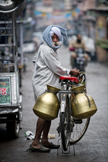 Milk seller with a turban and a bicycle
