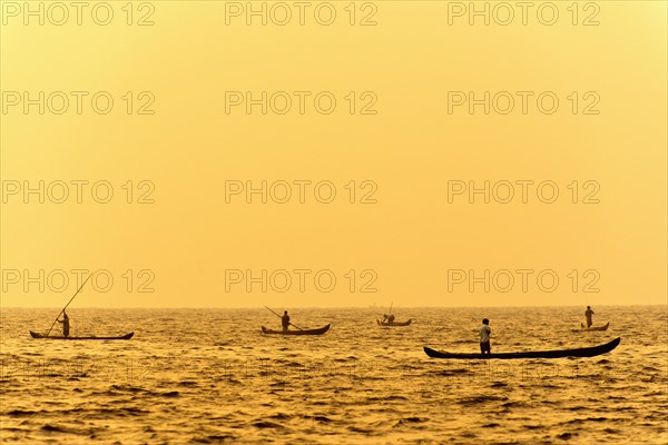 Fishermen in their boats at sunrise