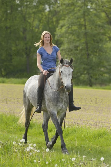 Woman trotting bareback on a Connemara mare