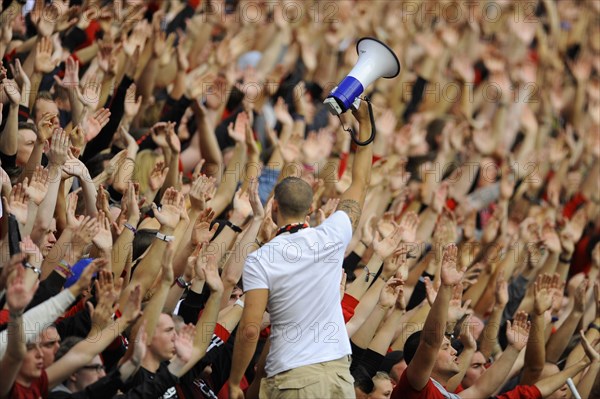 Fans of football club Bayer 04 Leverkusen cheering on their team