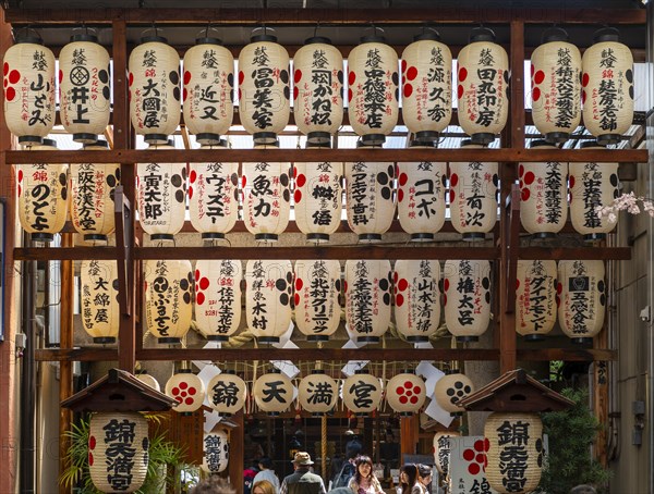 Japanese lanterns hanging in a passageway between houses