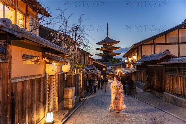 Woman in kimono in a lane