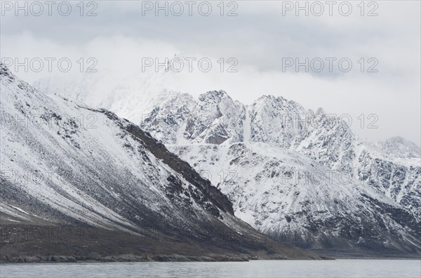 Snow covered peaks in clouds