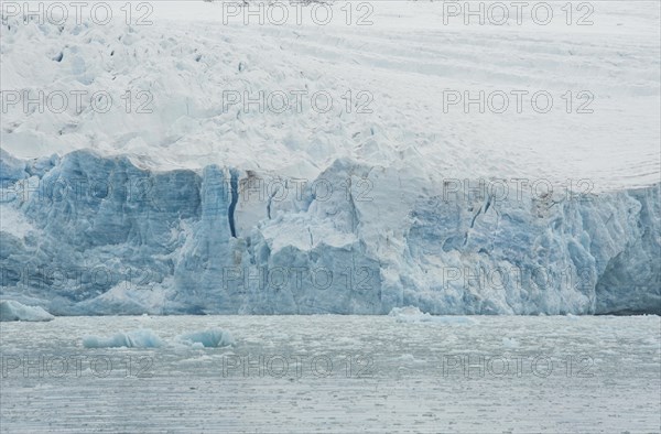 Ice avalanche into the water of a fjord