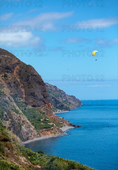 Cliff coast near Calheta with paragliders