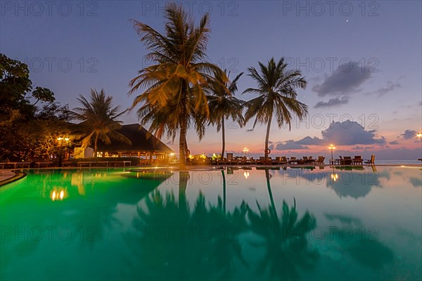 Restaurant and pool area of Paradise Island at dusk