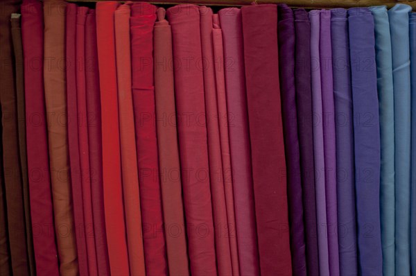 Fabrics lined up on a rack